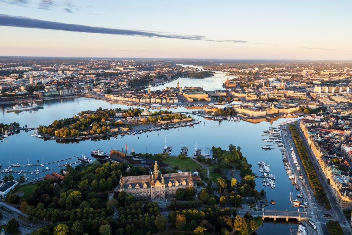 Aerial view of a cityscape with water channels and buildings at sunset.