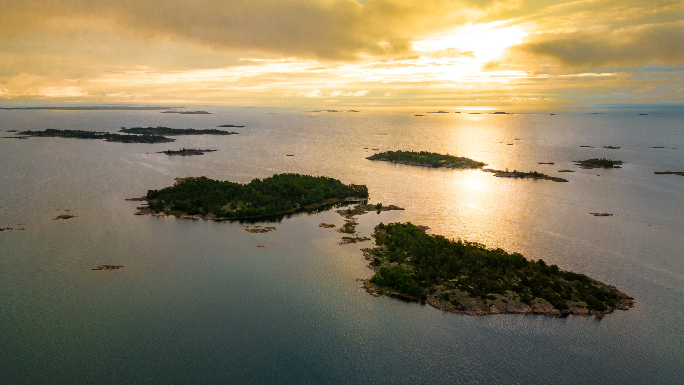 Aerial view of islands and sea at sunset.